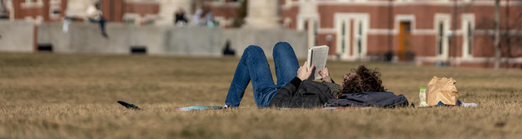Student reading on the Quad.