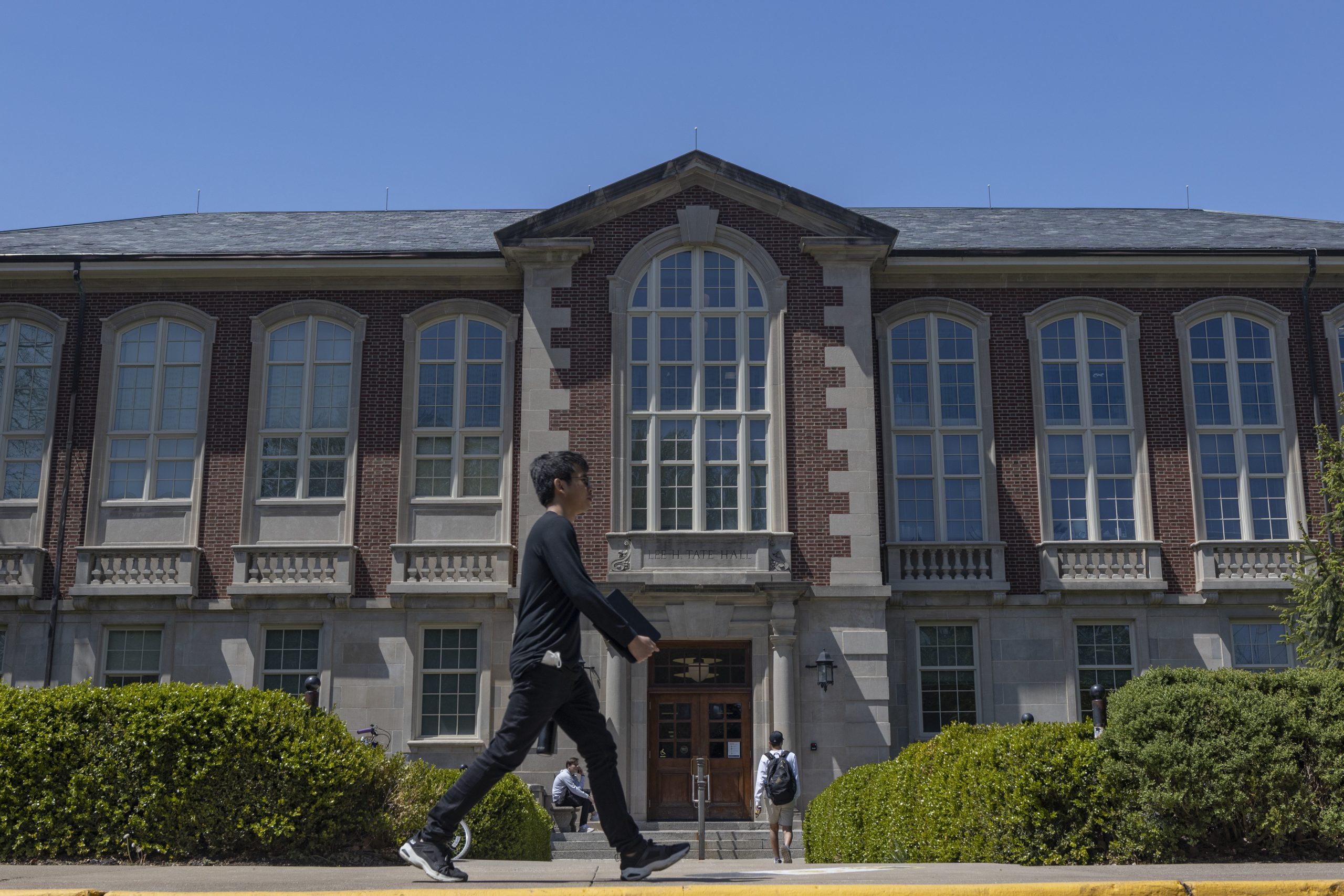 Student walk into Lee H. Tate Hall