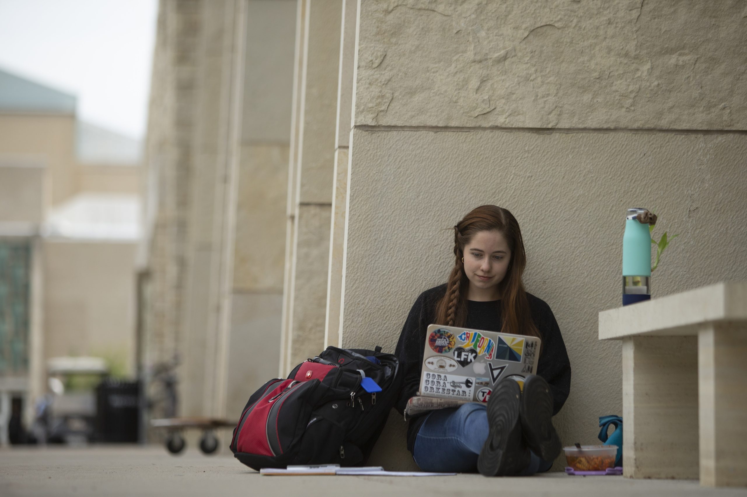 A young woman works on a laptop computer