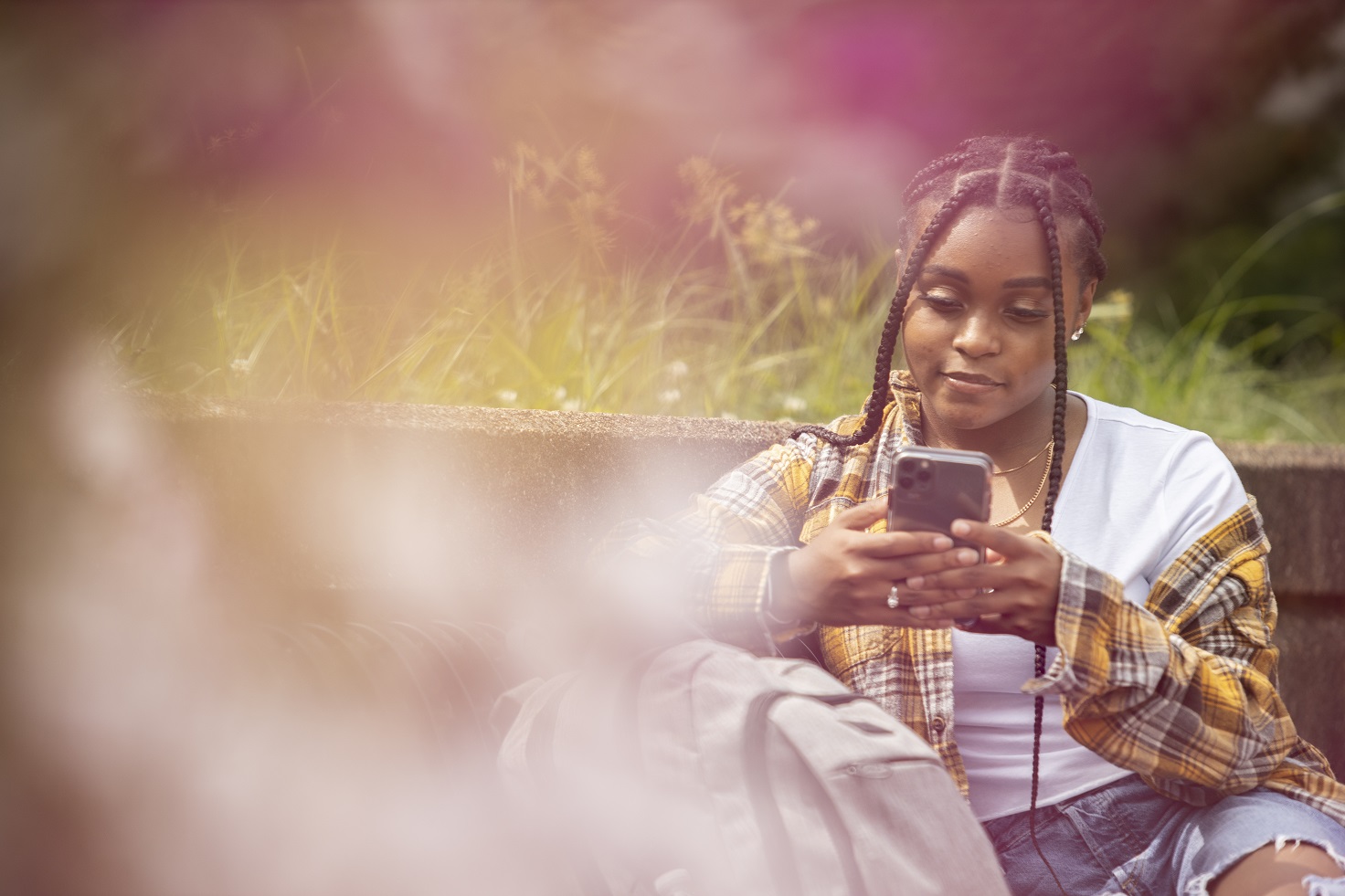 A young woman looks at her cellphone