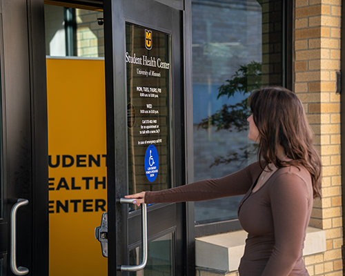 Student walking into Student Health Center.