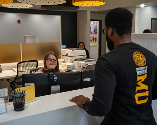 Student talking at front desk at Student Health Center.